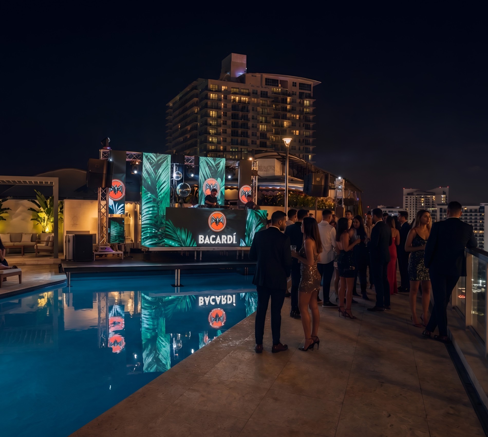 Rooftop DJ Event Production Music To Go night event production featuring a DJ booth with tropical Bacardi LED screens, stage lighting, and professional sound systems by a luxury rooftop pool